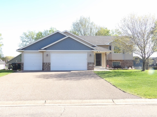 view of front of house with driveway, a front lawn, a garage, and brick siding