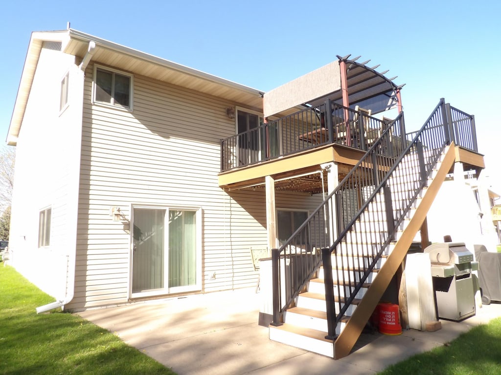 rear view of house featuring a patio area, a deck, and stairs