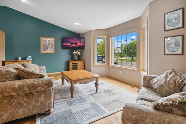1034 111th Ave NE, Blaine, MN 55434 - living room featuring lofted ceiling, wood finished floors, baseboards, and recessed lighting