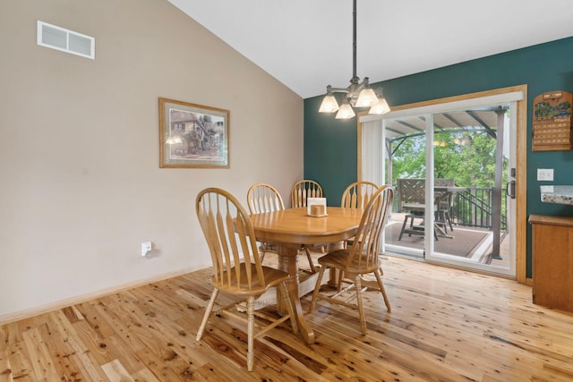 1034 111th Ave NE, Blaine, MN 55434 - dining space with light wood finished floors, a chandelier, baseboards, and high vaulted ceiling