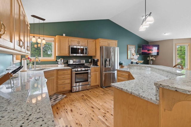 1034 111th Ave NE, Blaine, MN 55434 - kitchen with stainless steel appliances, a sink, vaulted ceiling, light wood-style floors, and light brown cabinets