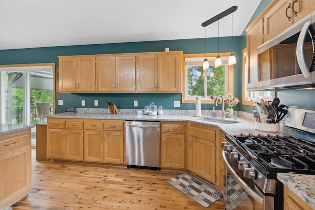 1034 111th Ave NE, Blaine, MN 55434 - kitchen with appliances with stainless steel finishes, a sink, healthy amount of natural light, and light wood-style floors