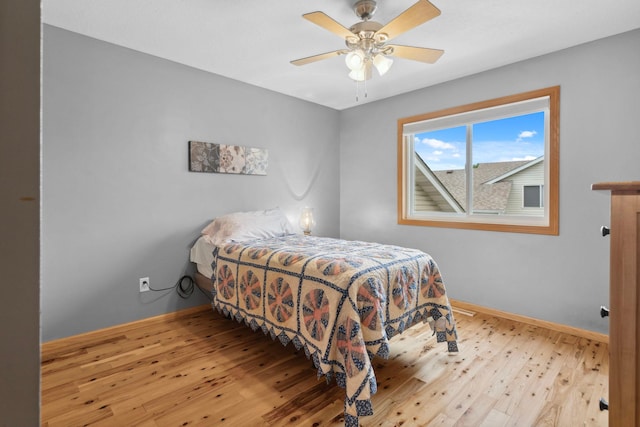 1034 111th Ave NE, Blaine, MN 55434 - bedroom with wood-type flooring, baseboards, and a ceiling fan
