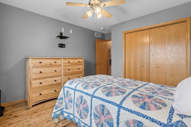 1034 111th Ave NE, Blaine, MN 55434 - bedroom featuring light wood finished floors, a closet, ceiling fan, and baseboards
