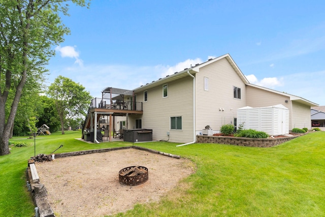 1034 111th Ave NE, Blaine, MN 55434 - back of house with a hot tub, a fire pit, a deck, and a yard