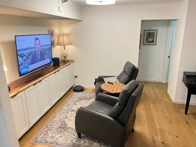 living area featuring light wood-type flooring and baseboards