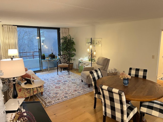 living room featuring light wood-type flooring and floor to ceiling windows