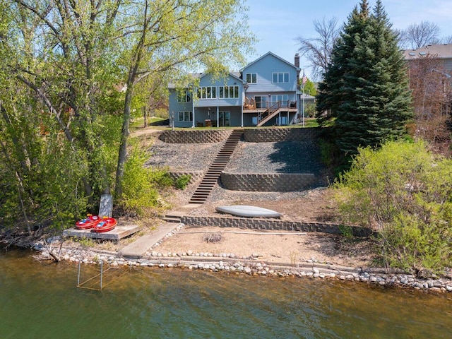 15825 Garden View Dr, Apple Valley, MN 55124 - back of property with a water view, a chimney, stairs, and a boat ramp