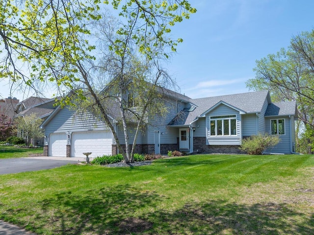 15825 Garden View Dr, Apple Valley, MN 55124 - tri-level home featuring asphalt driveway, a front yard, a garage, brick siding, and roof with shingles