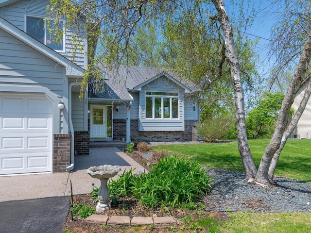15825 Garden View Dr, Apple Valley, MN 55124 - view of front facade with brick siding, a front yard, and a garage