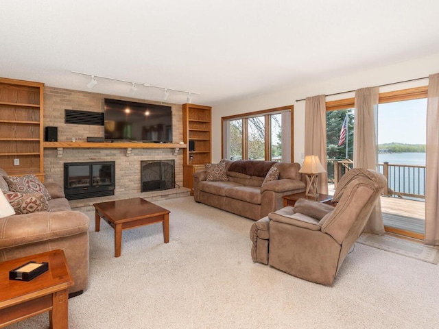 15825 Garden View Dr, Apple Valley, MN 55124 - carpeted living area featuring a fireplace, track lighting, and built in features
