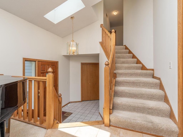 15825 Garden View Dr, Apple Valley, MN 55124 - tiled entryway featuring a skylight, high vaulted ceiling, and baseboards