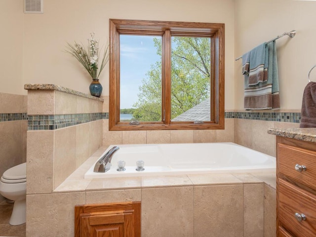 15825 Garden View Dr, Apple Valley, MN 55124 - bathroom featuring a garden tub, toilet, and vanity