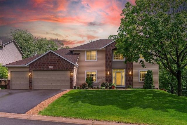 9230 Cheney Trl, Inver Grove Heights, MN 55076 - view of front of house featuring driveway, an attached garage, a yard, and brick siding