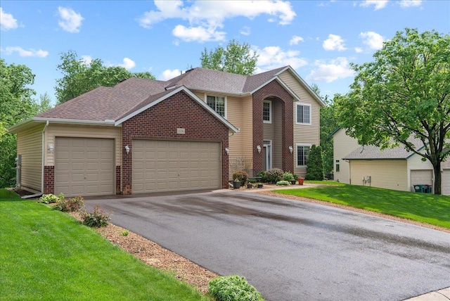 9230 Cheney Trl, Inver Grove Heights, MN 55076 - traditional-style home featuring brick siding, an attached garage, driveway, and a front lawn