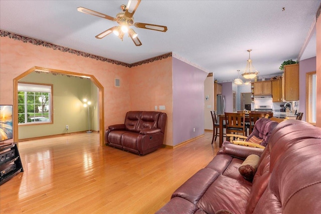 9230 Cheney Trl, Inver Grove Heights, MN 55076 - living area with light wood-type flooring, ceiling fan, arched walkways, and baseboards