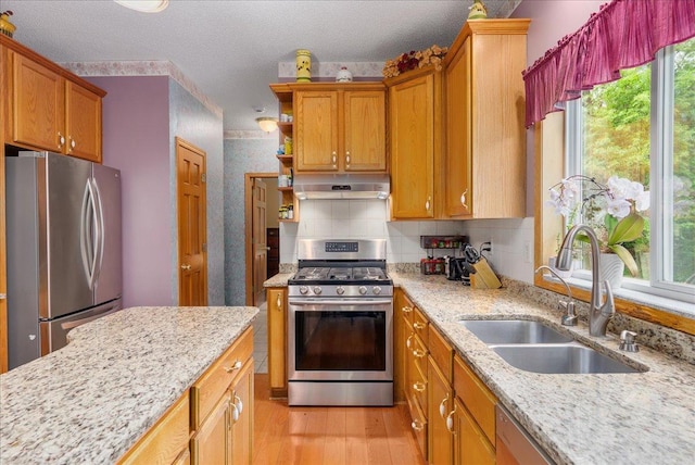 9230 Cheney Trl, Inver Grove Heights, MN 55076 - kitchen with stainless steel appliances, a sink, under cabinet range hood, healthy amount of natural light, and a textured ceiling