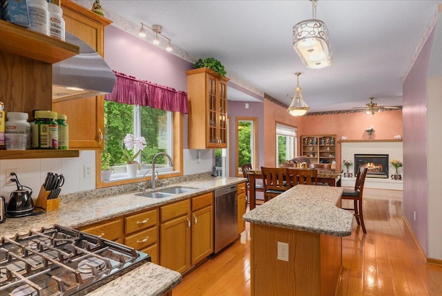 9230 Cheney Trl, Inver Grove Heights, MN 55076 - kitchen with a sink, stainless steel dishwasher, ceiling fan, brown cabinetry, and a kitchen island