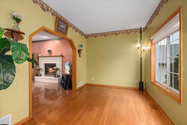 9230 Cheney Trl, Inver Grove Heights, MN 55076 - living room featuring hardwood / wood-style flooring, a brick fireplace, and baseboards