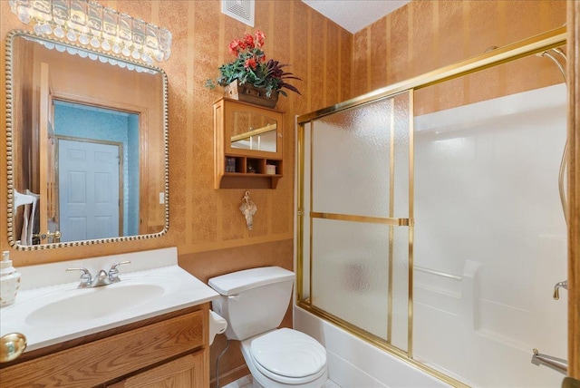 9230 Cheney Trl, Inver Grove Heights, MN 55076 - bathroom featuring wallpapered walls, vanity, toilet, and combined bath / shower with glass door