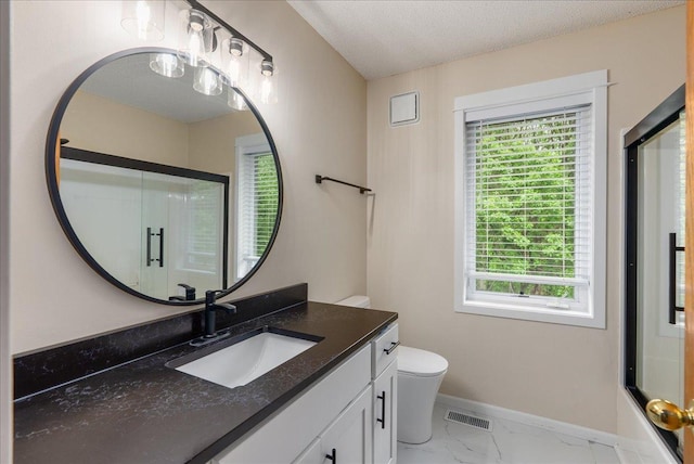 9230 Cheney Trl, Inver Grove Heights, MN 55076 - full bathroom featuring marble look tile flooring, a shower with shower door, baseboards, toilet, and vanity