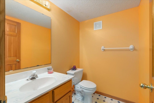 9230 Cheney Trl, Inver Grove Heights, MN 55076 - half bath with toilet, a textured ceiling, vanity, and tile patterned floors
