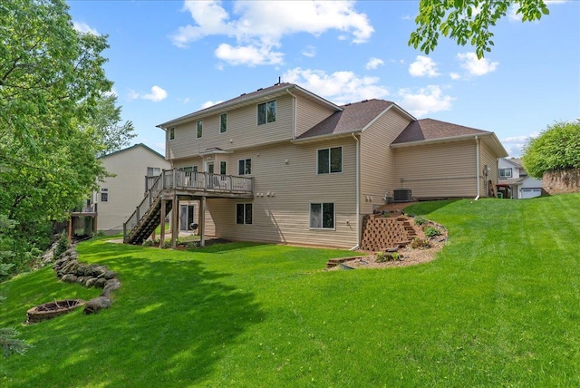 9230 Cheney Trl, Inver Grove Heights, MN 55076 - rear view of property featuring stairway, a wooden deck, a yard, and an outdoor fire pit