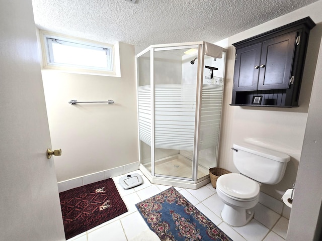 bathroom featuring toilet, a shower stall, tile patterned flooring, a textured ceiling, and baseboards