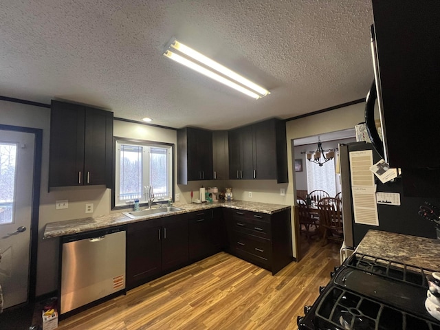 7424 Ely Lake Dr, Fayal Twp, MN 55734 - kitchen featuring stainless steel dishwasher, a sink, a textured ceiling, light wood-type flooring, and healthy amount of natural light