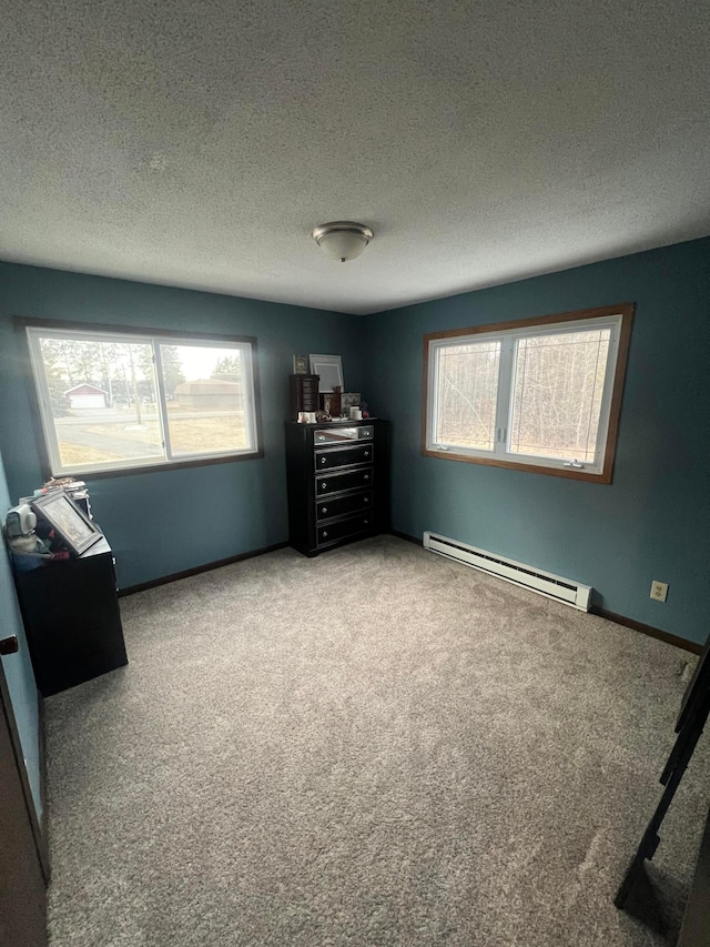 7424 Ely Lake Dr, Fayal Twp, MN 55734 - carpeted bedroom featuring a baseboard heating unit, a textured ceiling, multiple windows, and baseboards