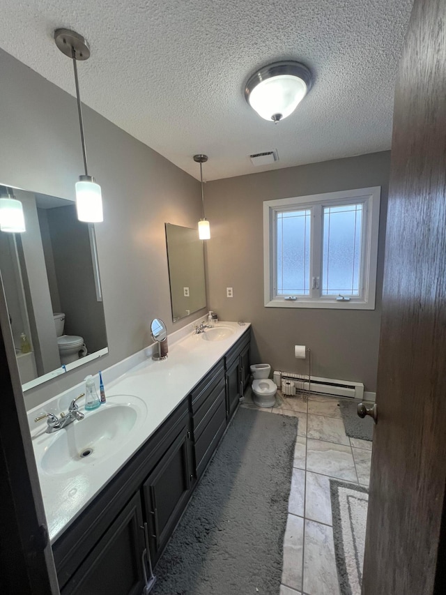 7424 Ely Lake Dr, Fayal Twp, MN 55734 - bathroom with a baseboard radiator, toilet, a textured ceiling, and double vanity