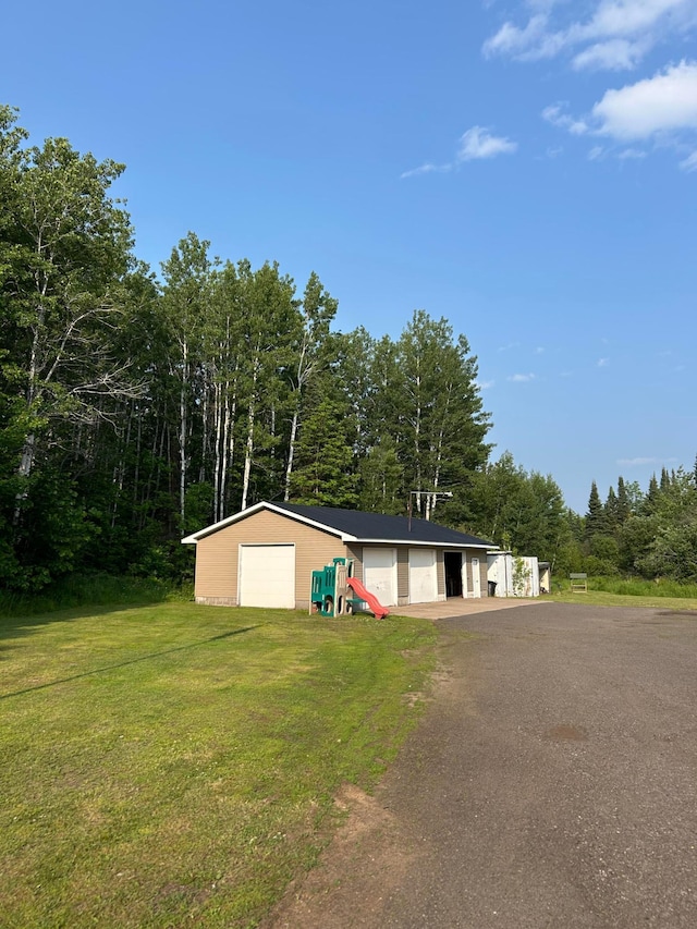 7424 Ely Lake Dr, Fayal Twp, MN 55734 - single story home with an outbuilding, a detached garage, a front lawn, and driveway