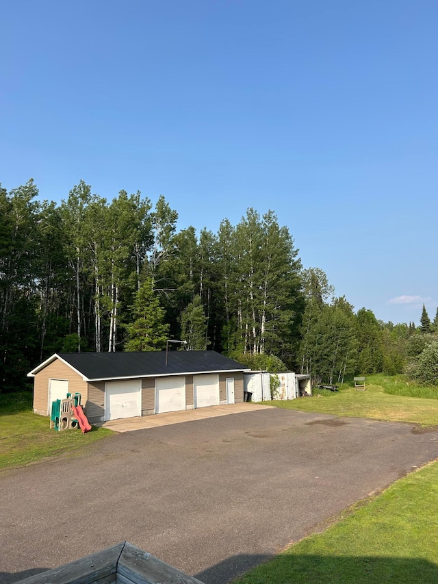 7424 Ely Lake Dr, Fayal Twp, MN 55734 - view of front of property with an outbuilding, a garage, and a forest view