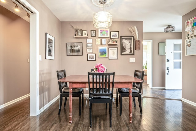 dining area with wood finished floors and baseboards