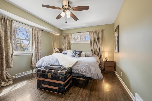 bedroom featuring wood finished floors, baseboards, and ceiling fan