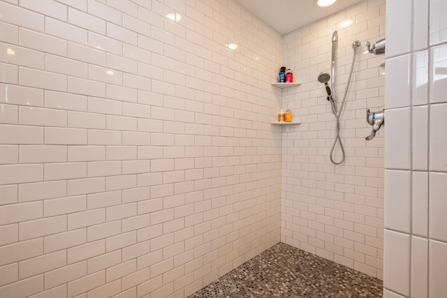 bathroom with a tile shower and recessed lighting