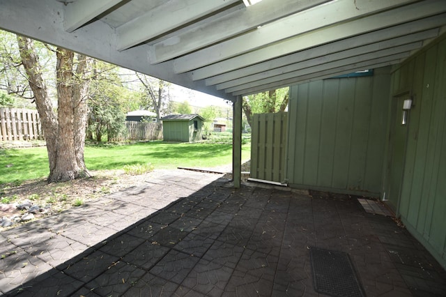 view of patio / terrace with a storage shed and an outdoor structure