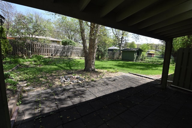 view of patio with a storage unit and an outbuilding