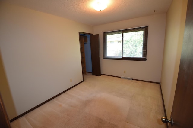 unfurnished room with light carpet and baseboards