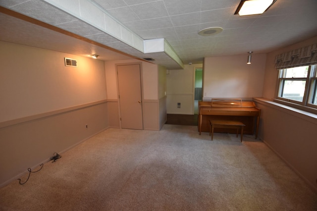 below grade area with light colored carpet