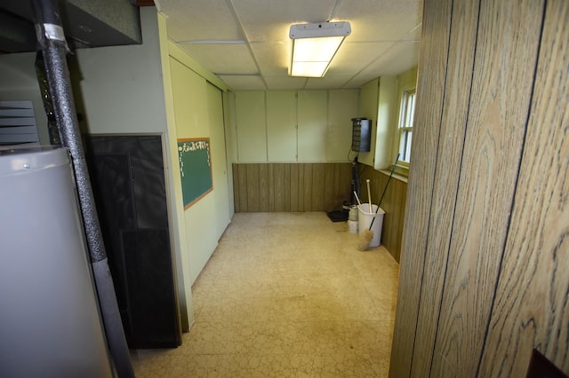 basement with wooden walls and light floors