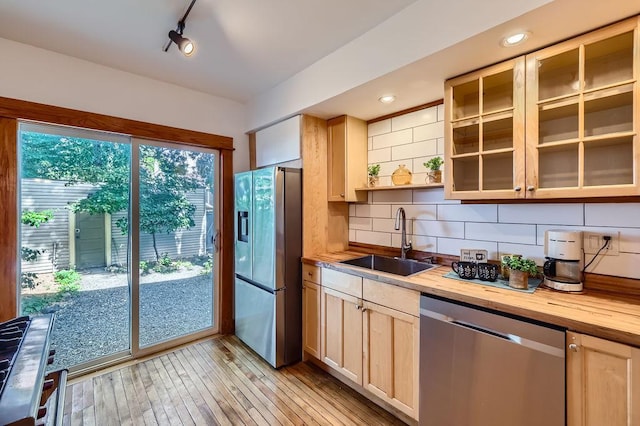 984 Milton St N, Saint Paul, MN 55103 - kitchen featuring stainless steel appliances, butcher block counters, tasteful backsplash, and light wood-type flooring
