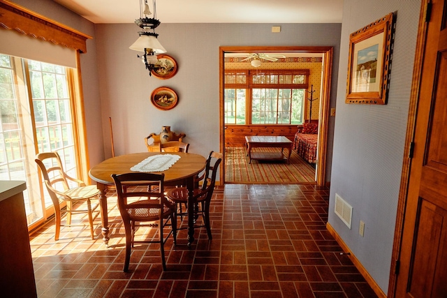 16865 Terrey Pine Dr, Eden Prairie, MN 55347 - dining area with brick patterned flooring, plenty of natural light, and baseboards