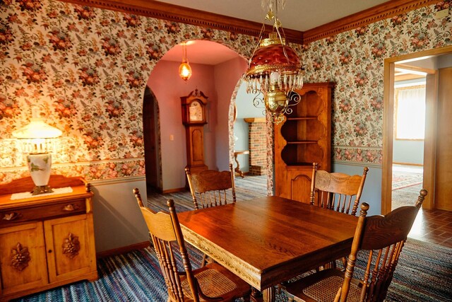 16865 Terrey Pine Dr, Eden Prairie, MN 55347 - dining room featuring wallpapered walls, arched walkways, a wainscoted wall, and baseboards
