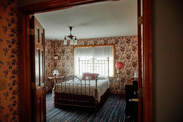 16865 Terrey Pine Dr, Eden Prairie, MN 55347 - bedroom featuring wallpapered walls, dark colored carpet, and a textured ceiling