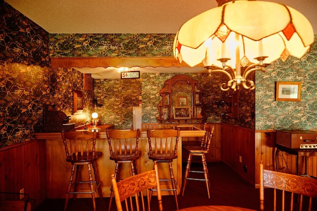 16865 Terrey Pine Dr, Eden Prairie, MN 55347 - indoor bar with wallpapered walls, wainscoting, a chandelier, a textured ceiling, and wood walls