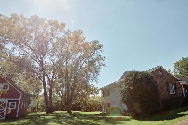 16865 Terrey Pine Dr, Eden Prairie, MN 55347 - view of side of property featuring a lawn, a barn, brick siding, and an outdoor structure