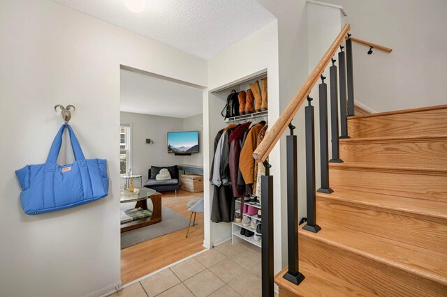 3214 Blaisdell Ave, Minneapolis, MN 55408 - entrance foyer with light tile patterned floors, a textured ceiling, and stairway