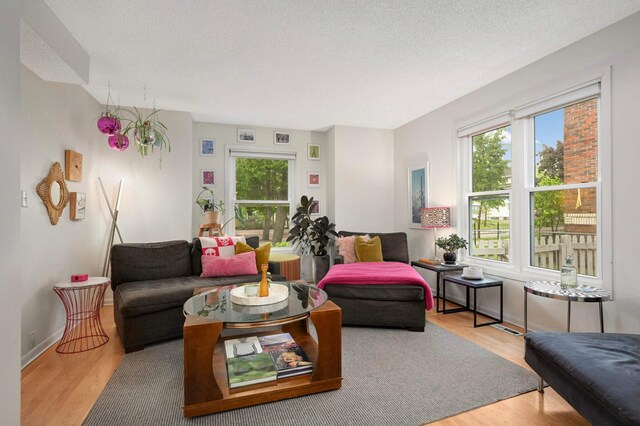 3214 Blaisdell Ave, Minneapolis, MN 55408 - living area with wood finished floors, a textured ceiling, and baseboards