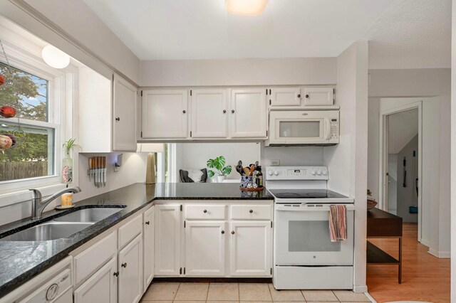 3214 Blaisdell Ave, Minneapolis, MN 55408 - kitchen with white appliances, a sink, white cabinets, and dark stone counters